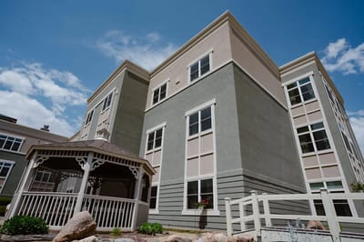 Exterior view of a senior living facility with gazebo.