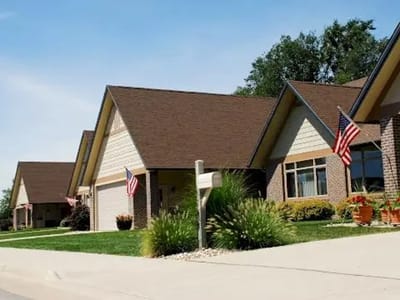 Exterior view of residential buildings with flags