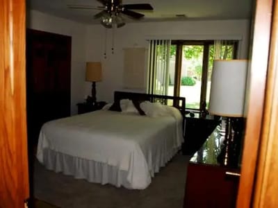 A cozy bedroom with a double bed and lamps