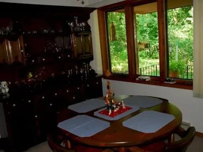 Dining area with wooden furniture and view of nature