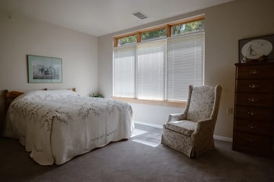 Cozy bedroom with a bed and chair