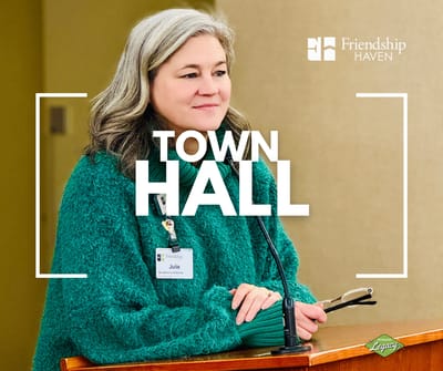 Staff member speaking at a town hall meeting.