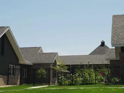Exterior view of assisted living facility buildings.