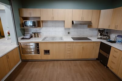 Modern kitchen space with wooden cabinetry.