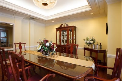 Elegant dining room setup with a floral centerpiece.
