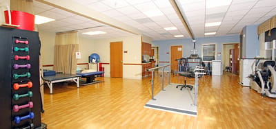Rehabilitation area with therapy equipment and exercise space.