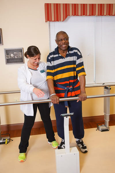 A staff member assisting a resident in therapy