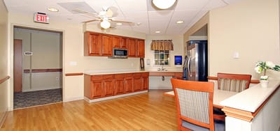 Bright kitchen area with wooden cabinets and seating.