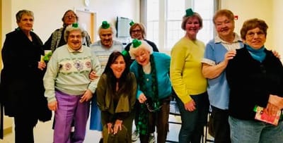 Residents and staff celebrating with green hats