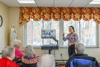 Residents enjoying an activity with a performer
