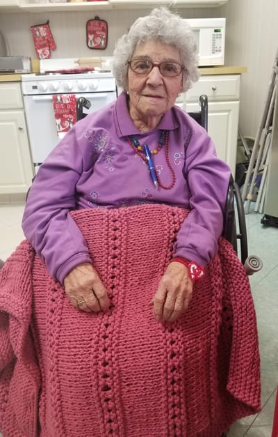 Senior resident in a wheelchair with a blanket