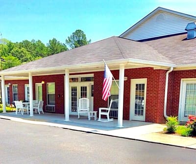 Exterior view of a nursing home with an American flag