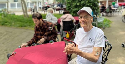 Resident enjoying activities outdoors with bubbles.