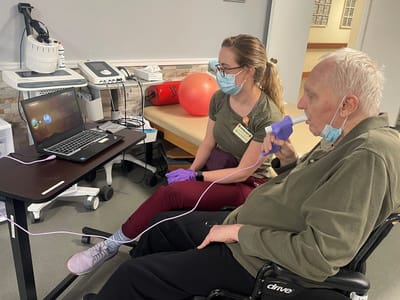 Staff member assisting a resident with therapy.