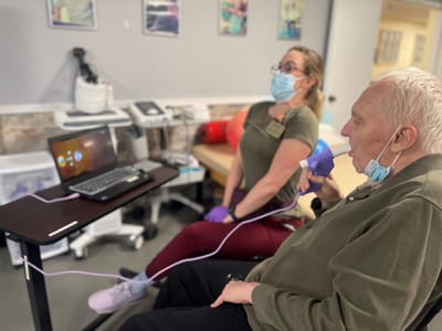 Therapist assisting a resident with treatment.
