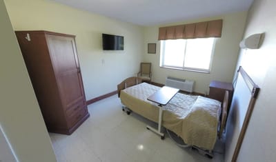 Private resident room with bed and furniture