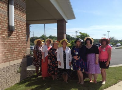 Group of staff wearing themed hats outside