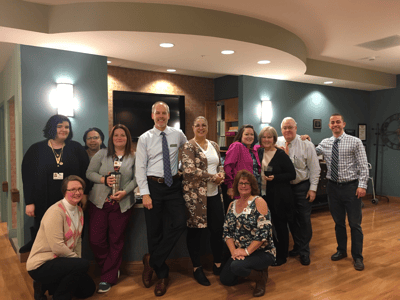 Staff members posing in a common area