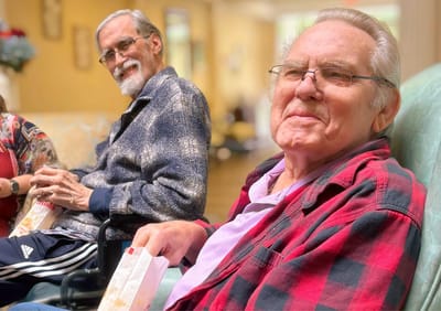 Two male residents enjoying time together in a common area.