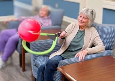 Senior resident engaging in an activity indoors.