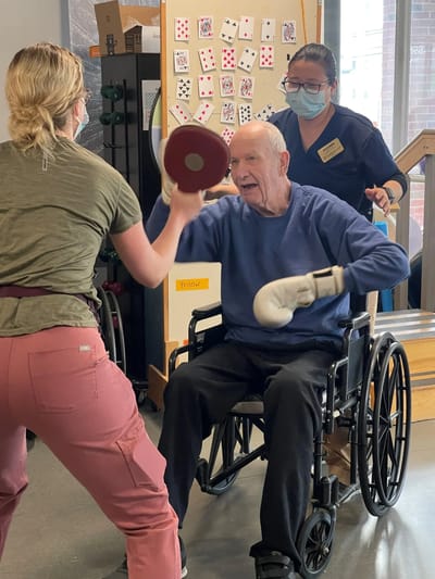 Resident engaging in activity with staff member