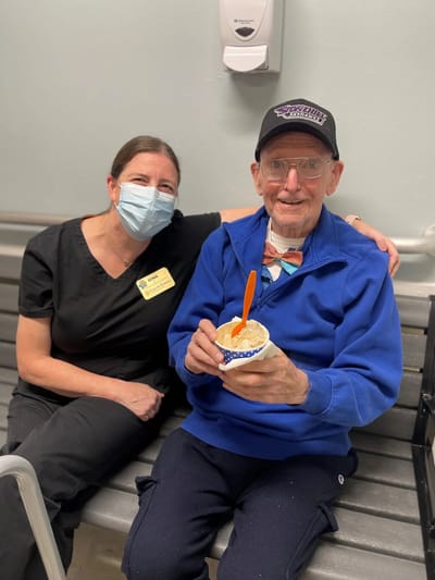 Staff member and resident enjoying a treat together.
