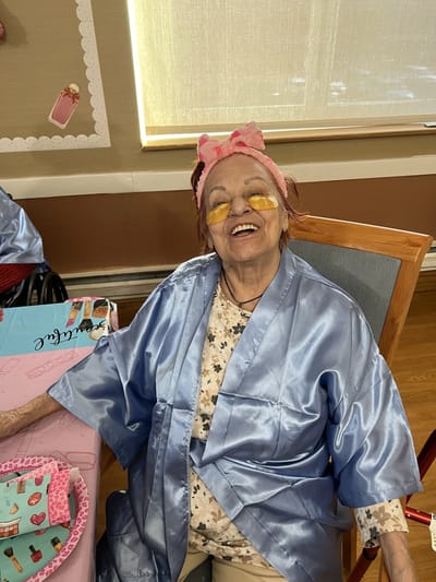 Senior resident enjoying an activity with a smile.