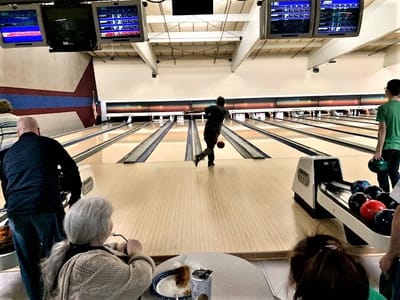 Residents enjoying a bowling activity together.