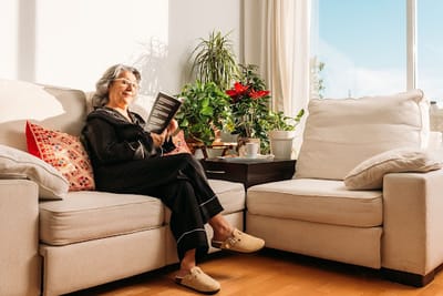 Senior woman reading in a sunlit room