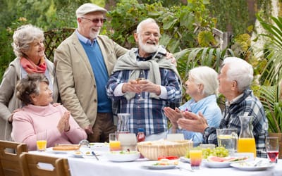 Residents enjoying a meal together outdoors.