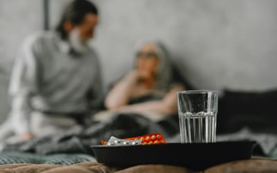 A blurred scene with a caregiver and a senior resident.