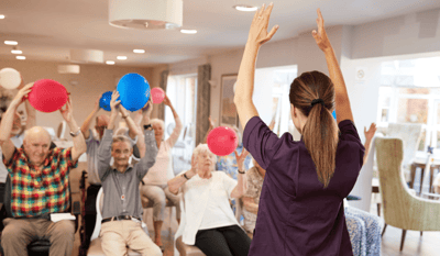 Residents participating in an engaging activity with balloons.