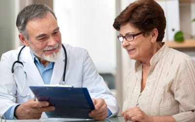 A doctor consulting with an elderly woman
