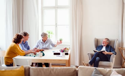 Residents engaging in conversation around a table.