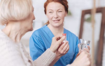 Caregiver assisting resident with medication