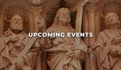 Carved statues with text about upcoming events