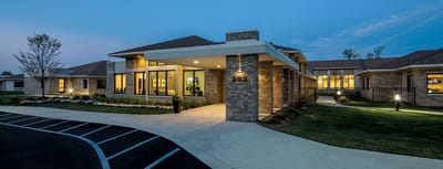 Exterior view of WellBridge of Novi at dusk.