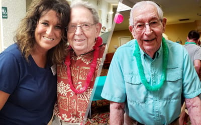 Staff member and resident enjoying a celebration together.