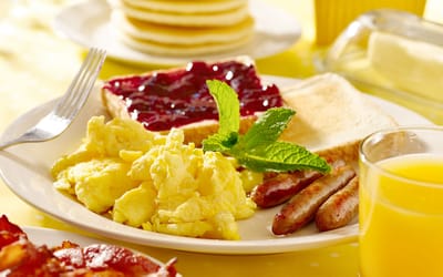 Plate of scrambled eggs, toast, and sausage