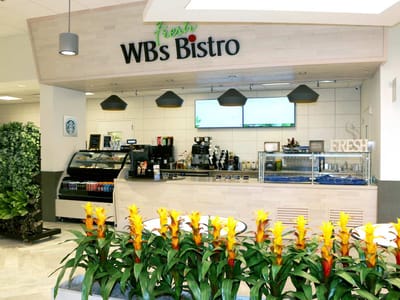 Bistro area with coffee and floral decorations.