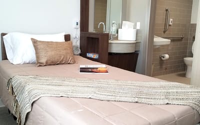Cozy private resident room with a bed and bathroom.