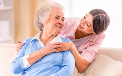Caregiver sharing a joyful moment with a senior resident.