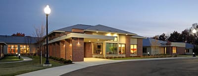 Exterior view of assisted living facility at dusk.