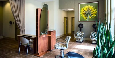 Hair salon area with modern decor and natural light.