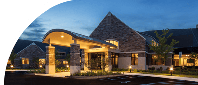 Exterior view of WellBridge of Novi at dusk