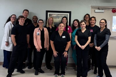 Staff members posing together in facility interior.