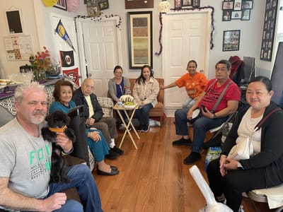 Residents and staff enjoying a social gathering indoors.
