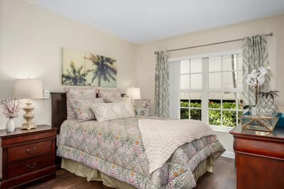 Cozy bedroom with floral bedding and natural light
