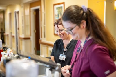 Staff smiling at the service counter in the facility's lobby