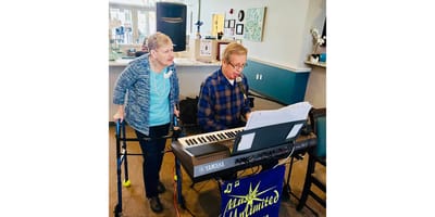 Residents enjoying live music in a common area